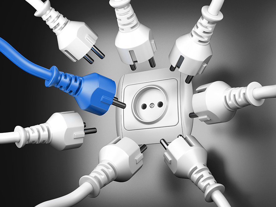 Red and white power plugs and a socket – leadership concept